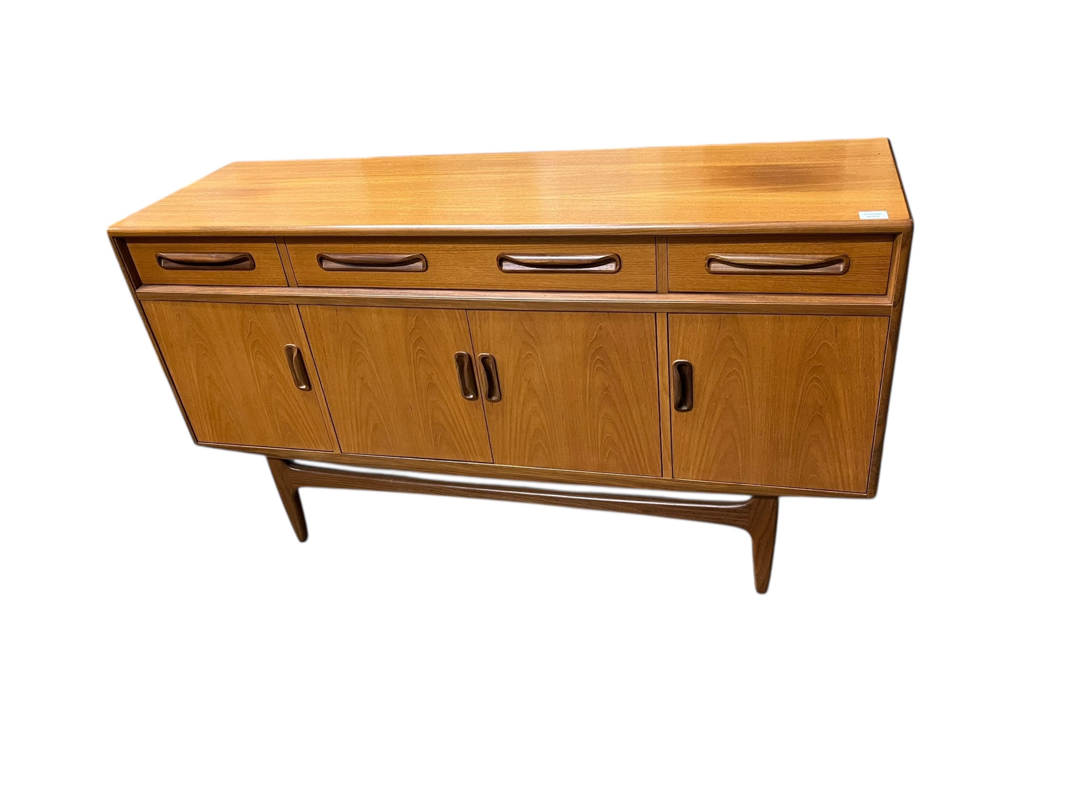 A mid century G Plan Fresco teak dining suite comprising dining table 184cm extended, depth 116cm, height 73cm, six chairs, two with arms and a four door sideboard, width 152cm